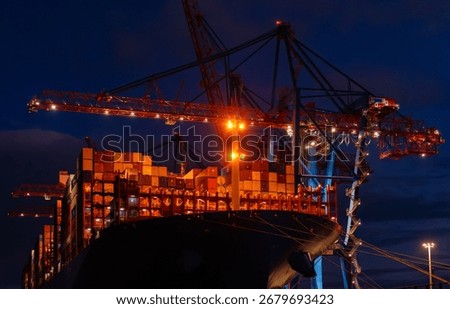 Overnight Unloading Of Large Ship With Containers In Cargo Port Container Terminal With Large Cranes