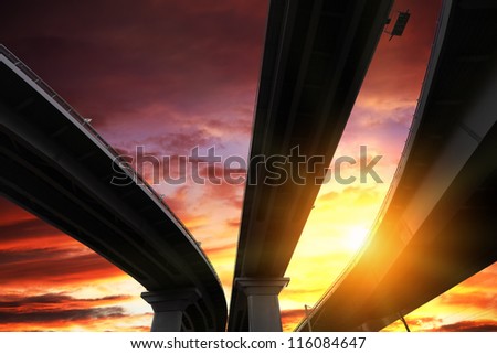 Overpass silhouette on sunset sky background