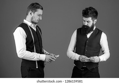 Overpayment Concept. Tailor, Greedy Designer Wants More Money For Expensive Clothes. Customer, Client Paying, Counting Money, Grey Background. Man With Beard Pay To Macho With Measuring Tape.