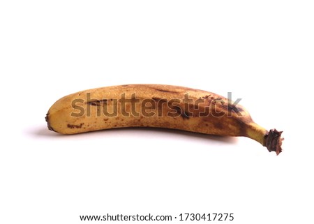 overripe expired yellow banana on the white background