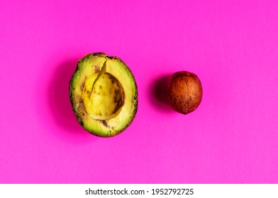 Over-ripe, Spoiled Avocado On A Pink Background.