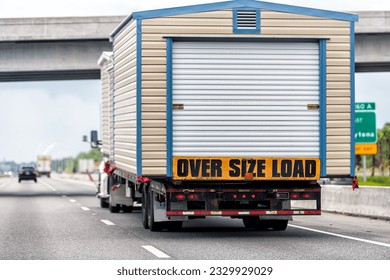 Oversize over size load hauler truck trailer vehicle hauling mobile module home house on North Carolina interstate highway road