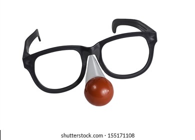 An oversize pair of eye glasses with a red nose isolated on a white background.