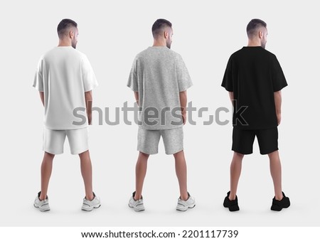 Oversized suit mockup, white, black, heather t-shirt, shorts on a guy in sneakers, back view, isolated on background. Male clothing template with place for design, pattern. Set apparel for advertising