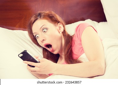 Oversleeping. Attractive young woman missed the ringing of the alarm clock and have overslept awakening and are late, reacting in horror at the time. Funny face expression, emotion, feeling, reaction