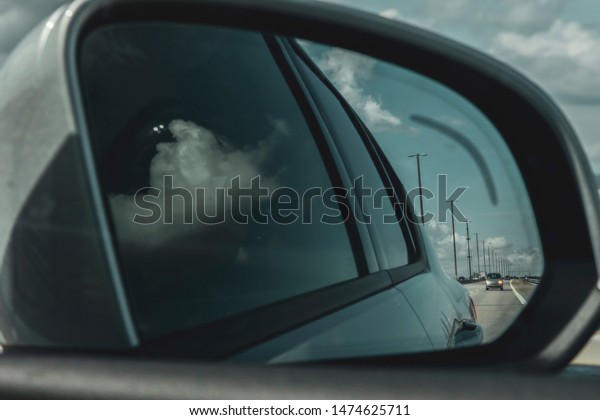 overtaking in the side mirror, driving car,\
safety on the road, speed\
background