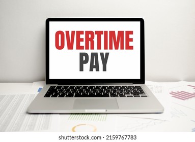 Overtime Pay Words On Laptop Display And Charts