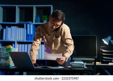 Overtime work concept, Handsome asian business man working late at night in office workplace. - Powered by Shutterstock