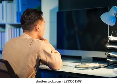 Overtime work concept, Handsome asian business man working late at night in office workplace. - Shutterstock ID 2233561599