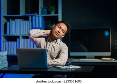Overtime work concept, Handsome asian business man working late at night in office workplace. - Shutterstock ID 2233561605