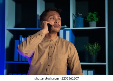 Overtime work concept, Handsome asian business man working late at night in office workplace. - Shutterstock ID 2233561607