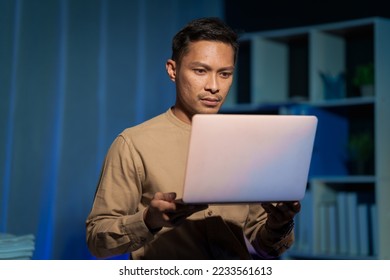 Overtime work concept, Handsome asian business man working late at night in office workplace. - Shutterstock ID 2233561613