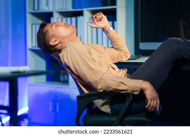 Overtime work concept, Handsome asian business man working late at night in office workplace. - Shutterstock ID 2233561621