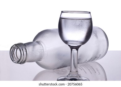 overturned bottle after vodka and glass