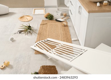 Overturned folding screen with things on floor in messy bathroom