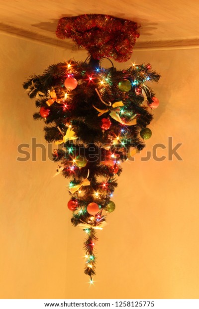 Overturned Glowing Christmas Tree On Ceiling Stock Photo