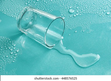 Overturned shot glass on turquoise background - Powered by Shutterstock