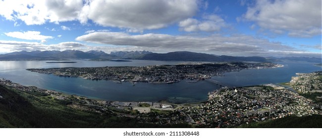 Overview Of Tromsø City, On Tromsøya Island. Blue Sea And Blue Sky With Some Clouds. Island Panorama. Norway.