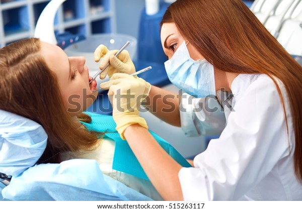 Overview of dental caries\
prevention.Woman at the dentist\'s chair during a dental procedure.\
Beautiful Woman smile close up. Healthy Smile. Beautiful Female\
Smile\
\
\
