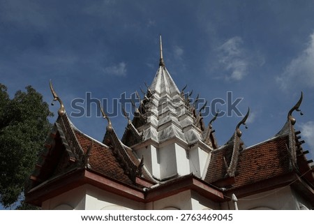 An overview of distinctive Thai architecture features a seven-tiered spire.