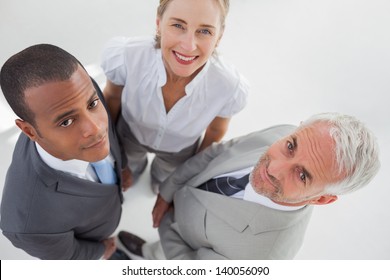 Overview Of Three Business People Standing Close To Each Other In The Workplace