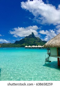 Overwater Bungalows Of A Luxury Resort Providing A View On The Otemanu, Bora Bora, Tahiti, French Polynesia