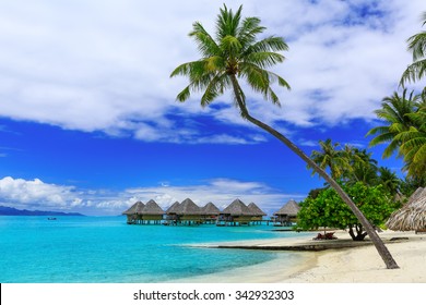 Over-water bungalows of luxury tropical resort, Bora Bora island, near Tahiti, French Polynesia, Pacific Ocean.