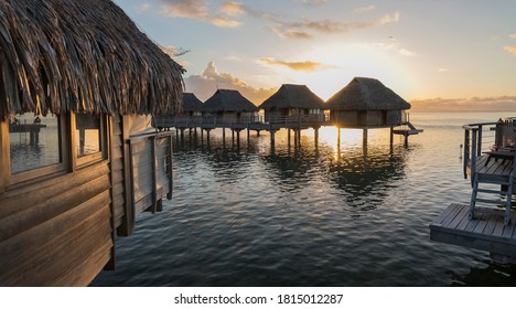 The Overwater Bungalows Of Moorea At Sunset.