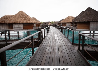 Overwater bungalows and wooden walkway over tropical turquoise water, French Polynesia
 - Powered by Shutterstock