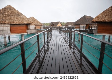 Overwater bungalows and wooden walkway over tropical turquoise water, French Polynesia
 - Powered by Shutterstock