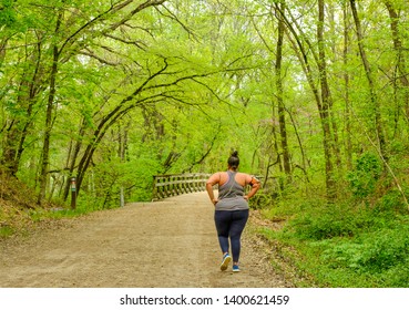 Overweight African American Woman Walking On Trail In Spring
