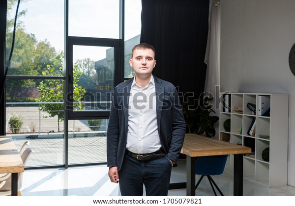 overweight businessman\
dressed suit in office. overweight business man in working place.\
Successful plus size worker in formal weart standing in job. topic\
of over weight.