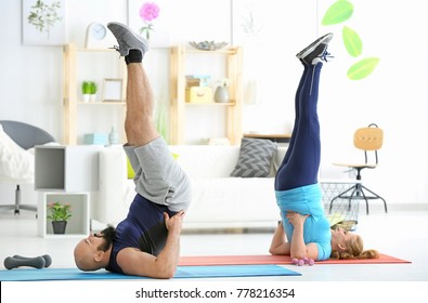 Overweight Couple Doing Exercises At Home