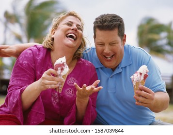 Overweight Couple Eating Ice Cream Cones