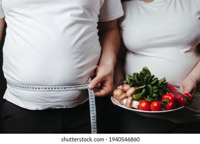 Overweight Couple With Healthy Food And Measure Tape