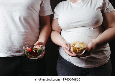 Overweight Couple With Healthy And Unhealthy Food