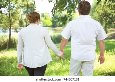 Overweight Couple In Park On Sunny Day