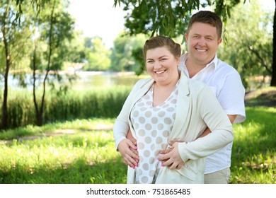 Overweight Couple In Park On Sunny Day