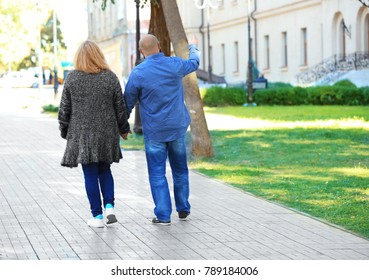 Overweight Couple Walking In Park