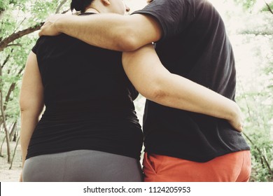 Overweight Couple Walking Together Hugging In Park. Weight Losing, Outdoor Activities, Healthy Lifestyle Concept.