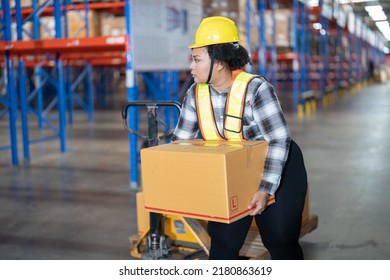 Overweight fat cholesterol woman in large warehouse  with high level of warehouse steel blue racking pulling hand pallet truck lift up the box looking around to find correct storage scan location
 - Powered by Shutterstock