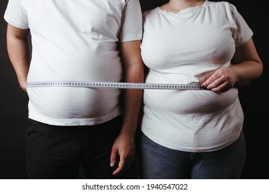 Overweight Fat Couple Wrapped With Measure Tape