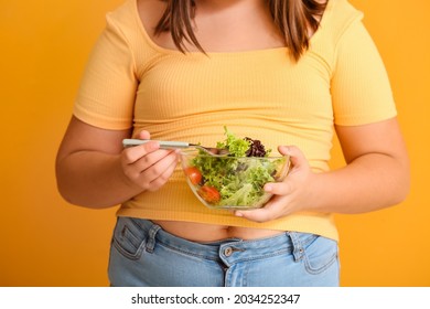 Overweight Girl Eating Healthy Vegetable Salad On Color Background