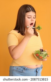 Overweight Girl Eating Healthy Vegetable Salad On Color Background