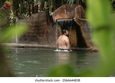 Overweight Man Enjoying A Natural Hot Springs Pool 