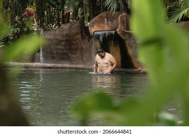 Overweight Man Enjoying A Natural Hot Springs Pool 