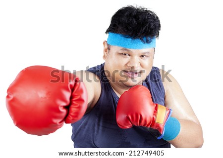 Overweight man exercise to lose weight by boxing. isolated on white background