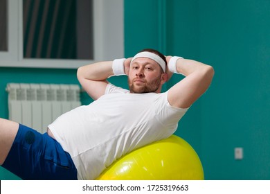 Overweight Man Is Lying On A Fitness Ball During Group Fitness Classes. Fat Man Looks Disappointed Because Of Bad Result Of Weight Loss Trainings