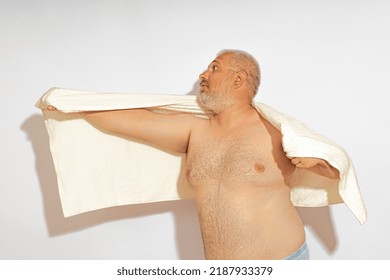 Overweight Man Showing Superman Sign. Flight Of Superman With A Naked Torso. Foolish Old Man On A White Background.