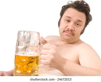 Overweight man sitting on the couch with a beer glass